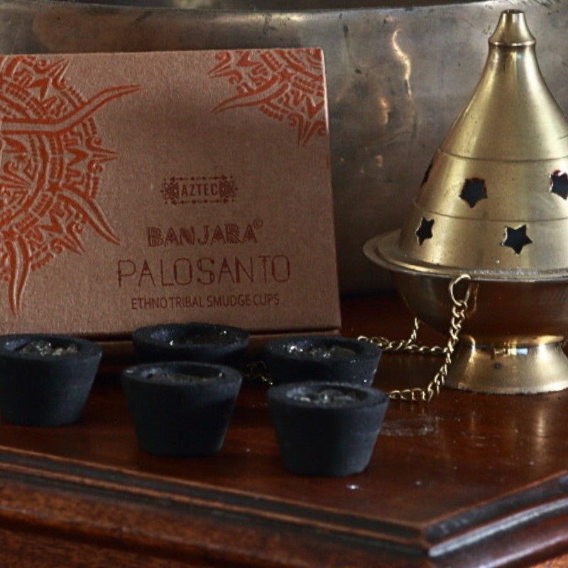 Banjara Smudge cups next to a brass thurible on a wooden table