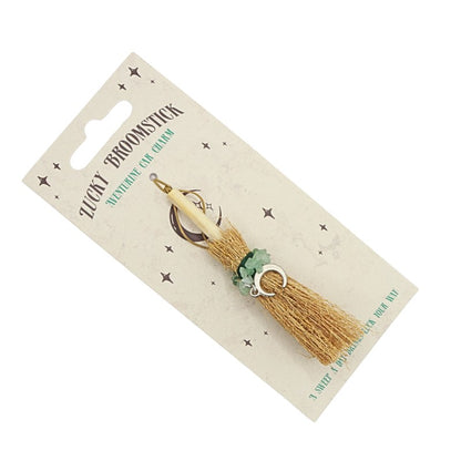 tiny broomstick car charm on card backing