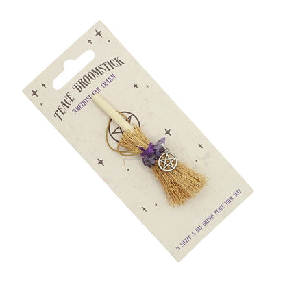 tiny broomstick car charm on card backing