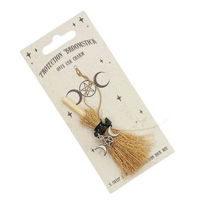 tiny broomstick car charm on card backing