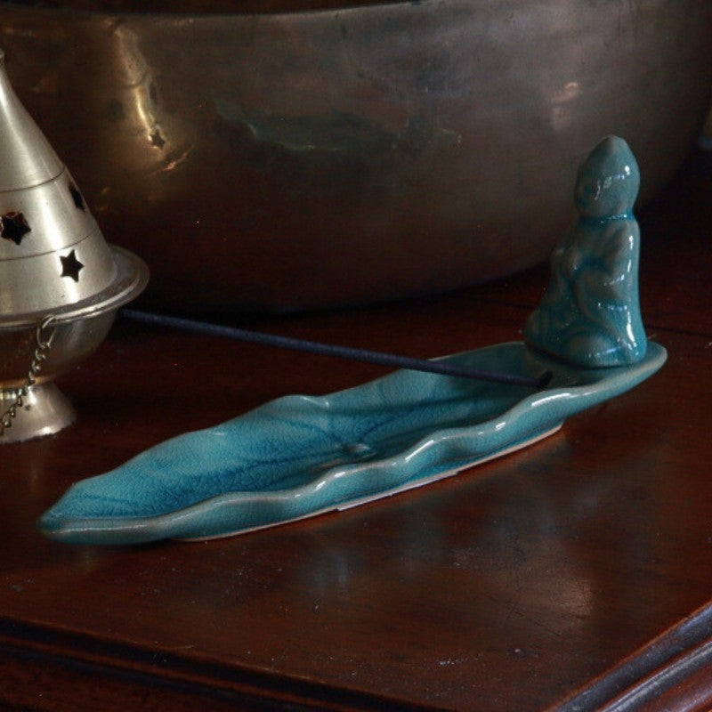 blue ceramic incense holder on wooden table