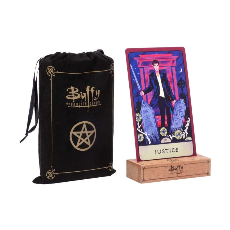 Black drawstring bag with 'Buffy the Vampire Slayer' branding and a tarot card featuring a character from the show on a wooden stand.