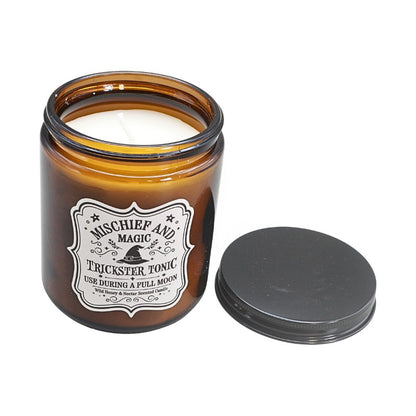 Brown Amber Glass jar with a white label  and a witches hat design next to a black lid