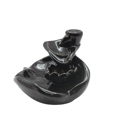 Black ceramic incense burner on a white background