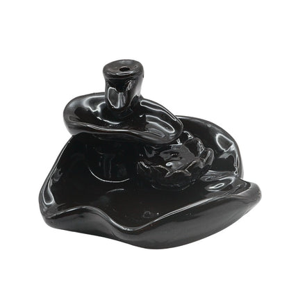 Black ceramic incense burner on a white background