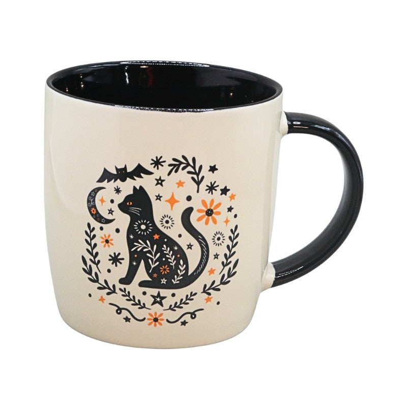 cream cup with black handle with an image of a black cat and black and orange floral design on a white background