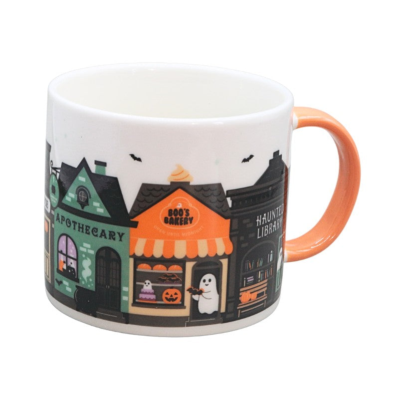  mug with spooky house designs on a white background