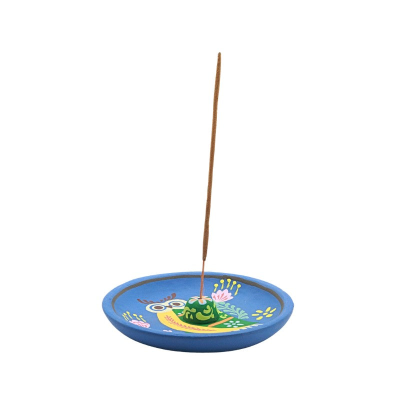 Colorful incense burner with a owl design on a white background