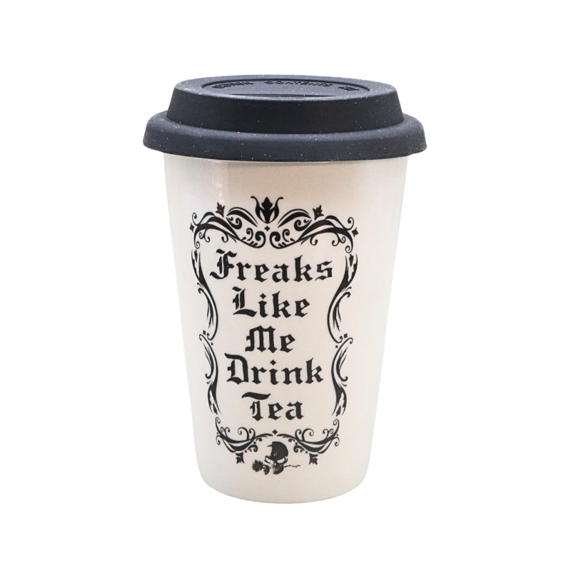 A white reusable coffee cup with a black lid, featuring the text 'Freaks Like Me Drink Tea' in a black gothic font with an ornate frame.