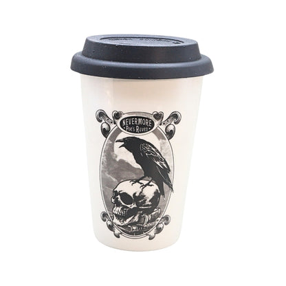 A white reusable coffee mug with a black lid, featuring a gothic-style graphic of a raven perched on a skull inside an oval frame with the text 'NEVERMORE Poe's Raven '.