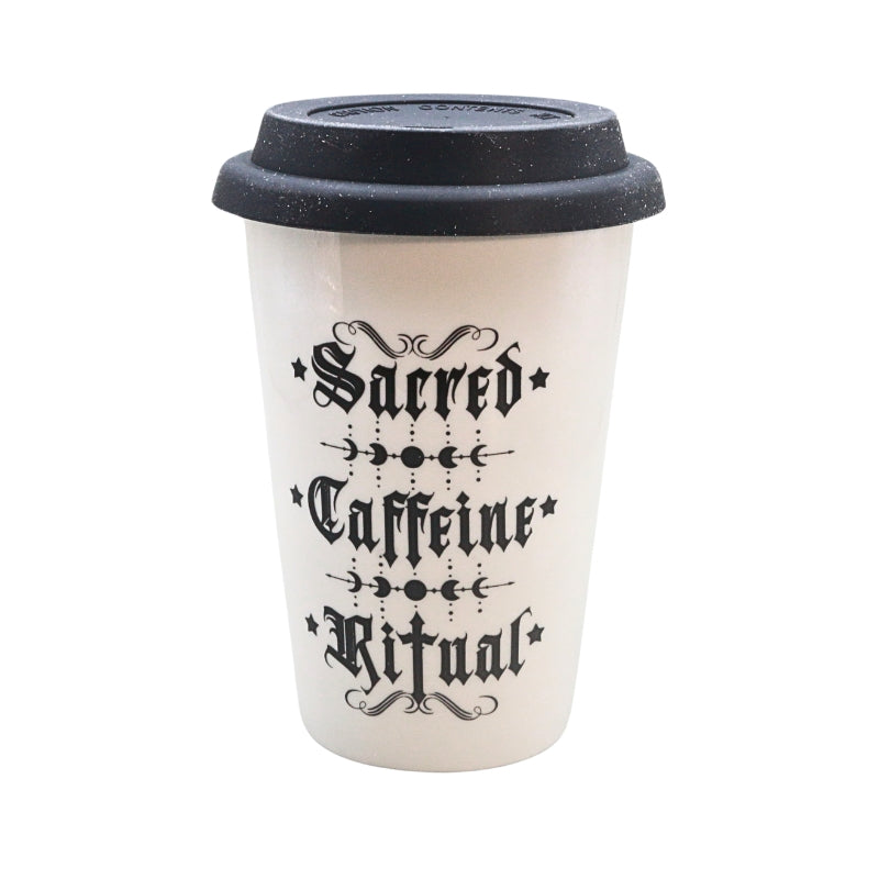 A white reusable coffee cup with a black lid, featuring the gothic-style text 'Sacred Caffeine Ritual' printed on the front.