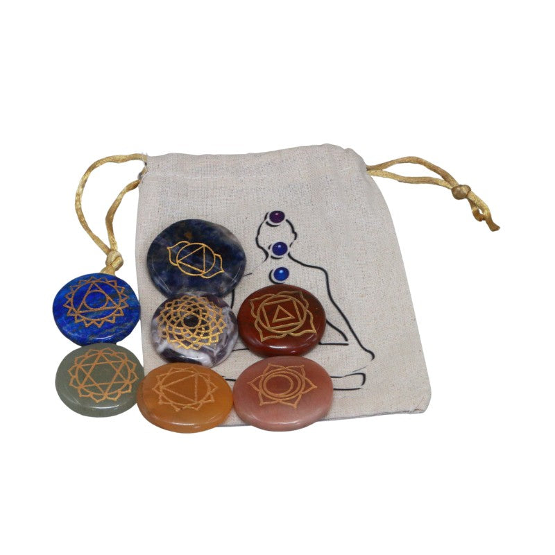 Set of chakra stones with a drawstring bag featuring a woman silhouette and symbols on a white background.