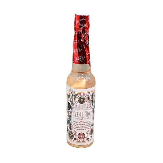 bottle of cleansing water with label that reads "peaceful home" with a floral design 