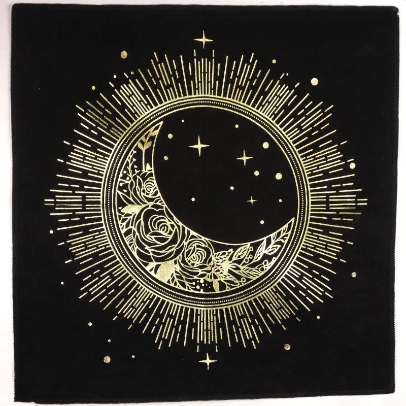 black altar cloth with a crescent moon printed in gold on the front surrounded by a circle with lines coming off it to represent the sun