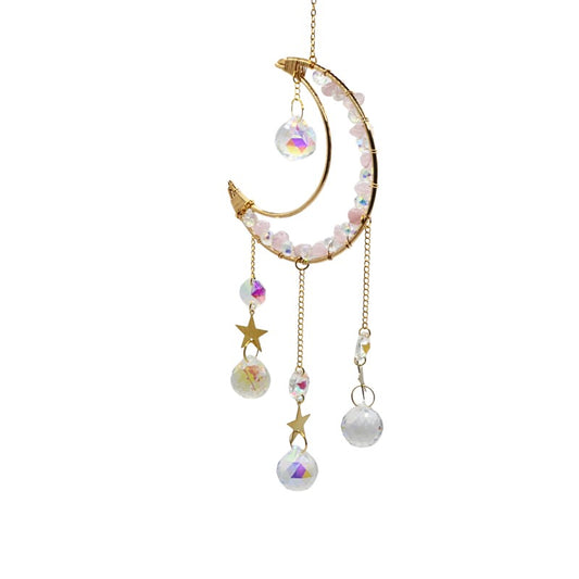Decorative hanging ornament with moon, stars, and beads on a white background
