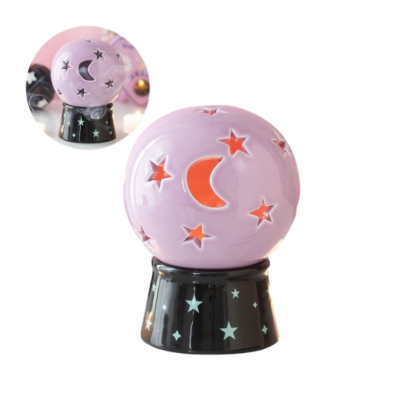 A decorative crystal tea light and incense cone holder with a lavender purple body, featuring a glowing orange crescent moon and star cutouts, displayed on a black base with star patterns. A circular inset in the top left shows the ball with smoke from incense wafting out of it