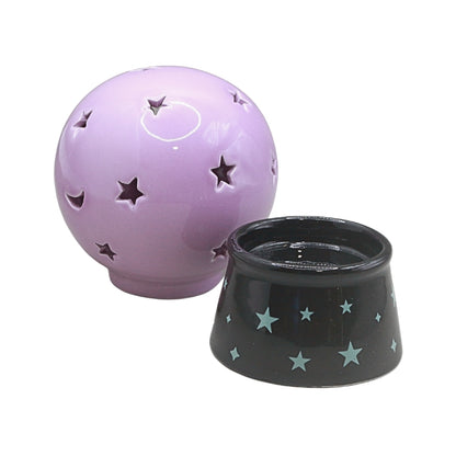 circular purple orb with moon and star cut outs and a black base with star designs