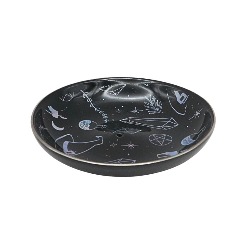 Black ceramic plate with witchy symbols  on a white background
