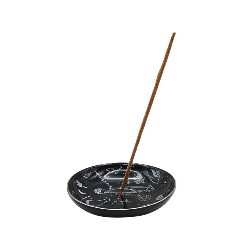 Black incense burner with a single incense stick on a white background