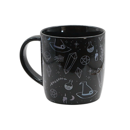 Black mug with witchy illustrations on a white background
