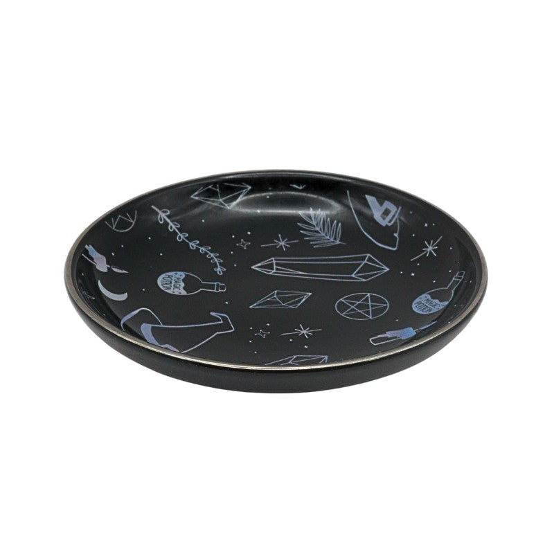 Black plate with white abstract designs on a white background