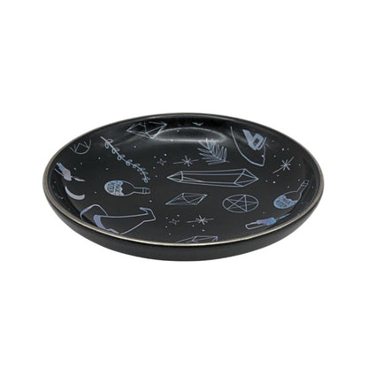 Black plate with white abstract designs on a white background