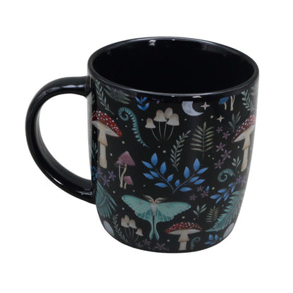 Black mug with nature-themed design featuring mushrooms and plants on a white background