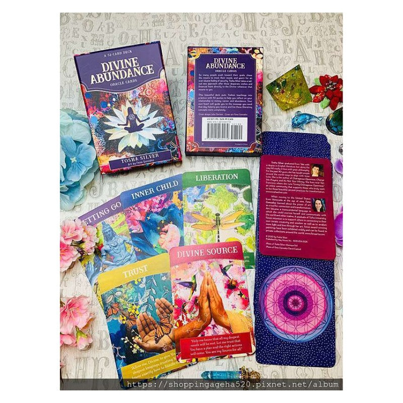 Divine abundance oracle cards- box and colourful cards laid out on table