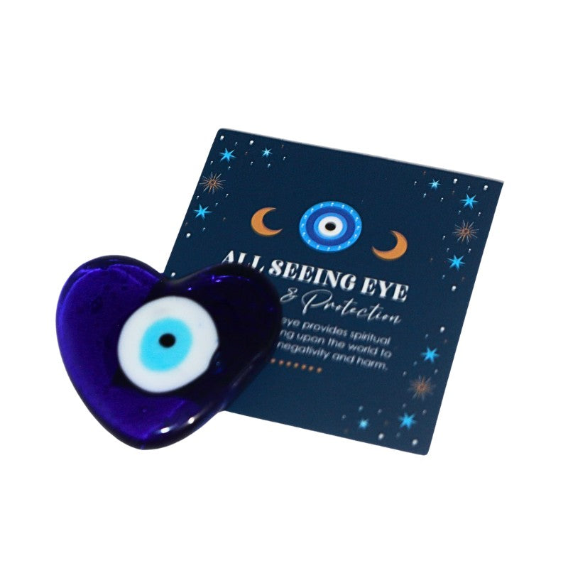 Blue heart-shaped evil eye amulet with a card explaining its meaning on a white background