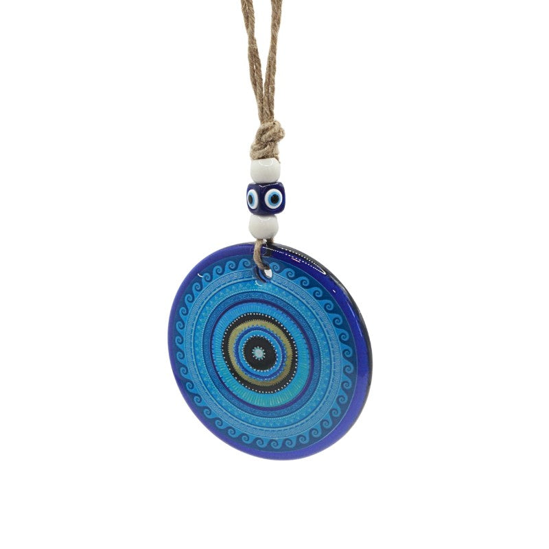 Decorative blue pendant with a string on a white background