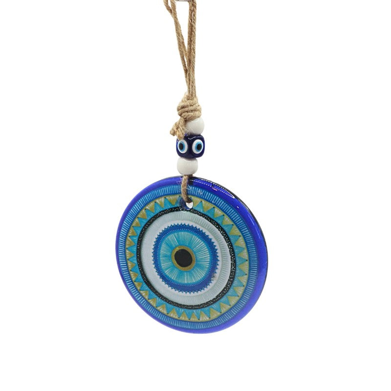 Decorative circular pendant with blue and white design on a white background