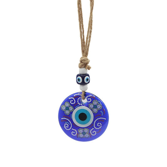Blue evil eye pendant wall hanging on a white background