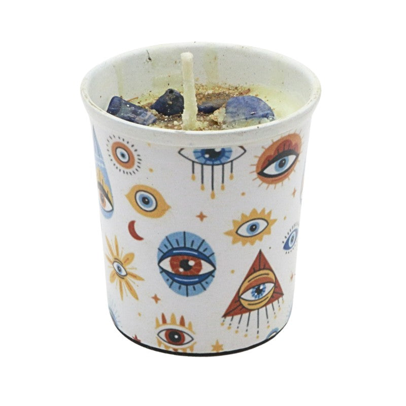 Candle in a container with eye designs on a white background