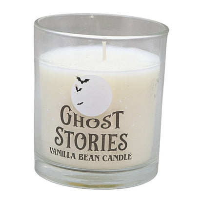 clear glass jar with white candle and label that says "ghost stories vanilla bean candle"