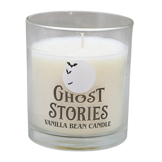 clear glass jar with white candle and label that says "ghost stories vanilla bean candle"