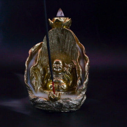 gold buddha backflow incense cone burner with smoke billowing around it