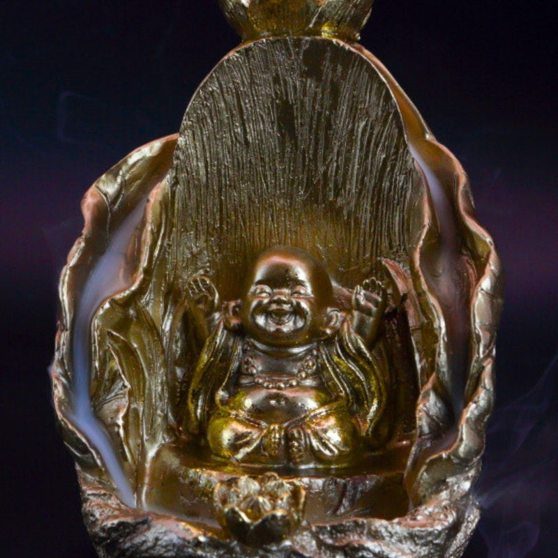 gold buddha backflow incense cone burner with smoke billowing around it
