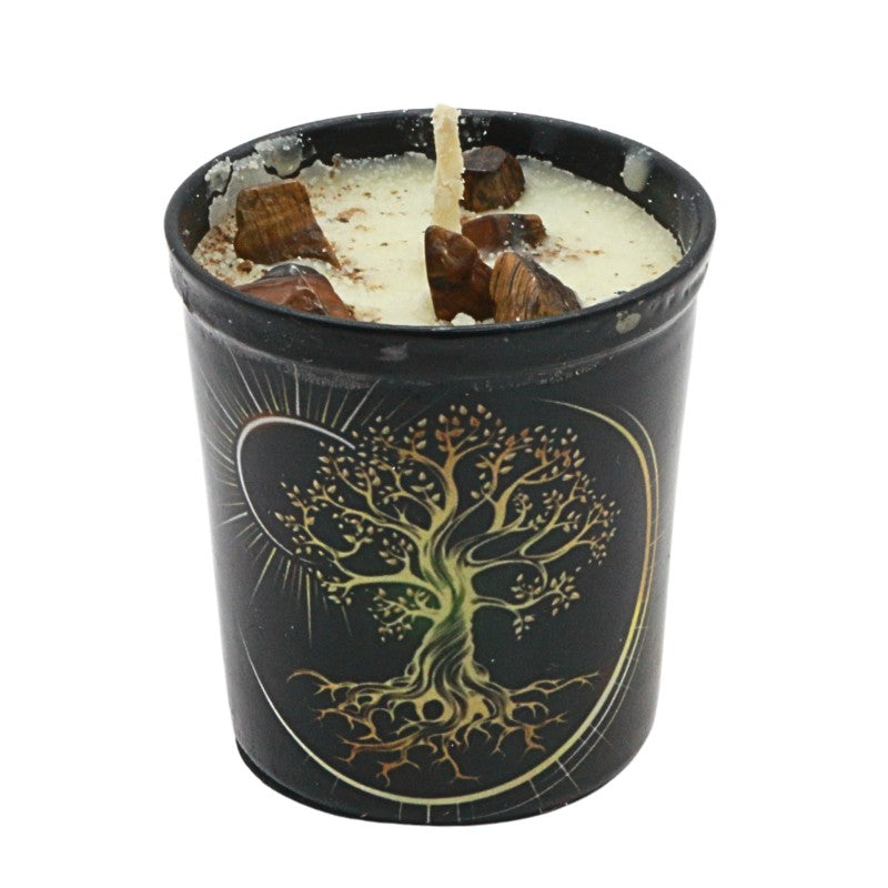 Candle in a black container with a tree design on a white background