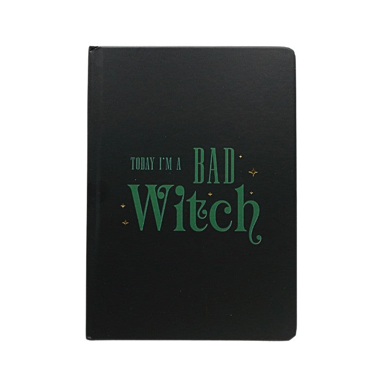 Black notebook with green text 'Today I'm a Bad Witch' on a white background