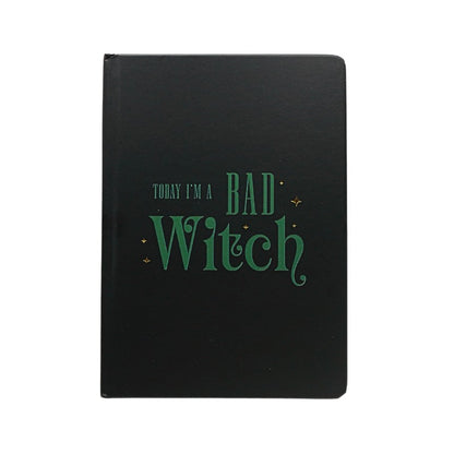Black notebook with green text 'Today I'm a Bad Witch' on a white background