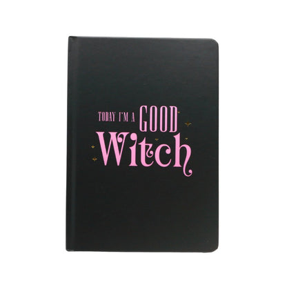 Black notebook with pink text 'Today I'm a Good Witch' on a white background