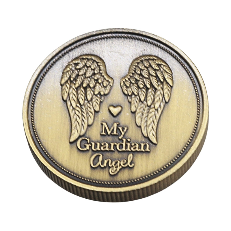 A round bronze-colored metal token or medallion featuring engraved angel wings, a small heart, and the words 'My Guardian Angel' on a plain white background.