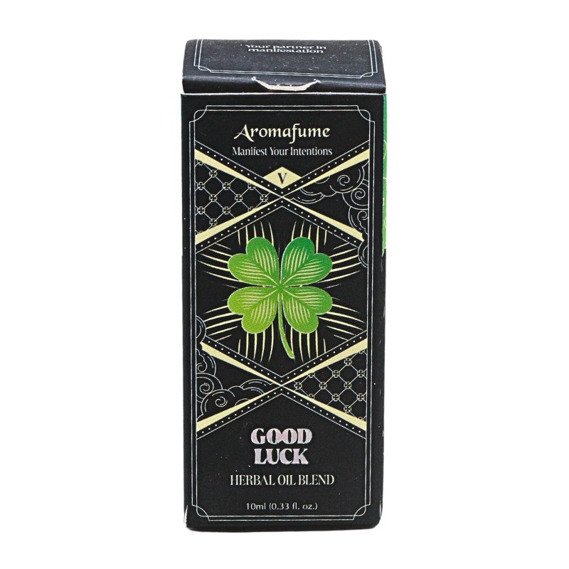 A rectangular black box of Aromafume Good Luck Herbal Oil Blend, featuring a green four-leaf clover design and gold decorative borders on a white background.