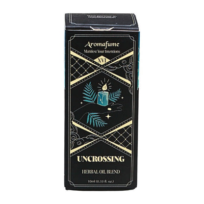 A rectangular black box for Aromafume 'Uncrossing' Herbal Oil Blend, featuring gold geometric borders and teal illustrations of a candle and leaves on a white background.