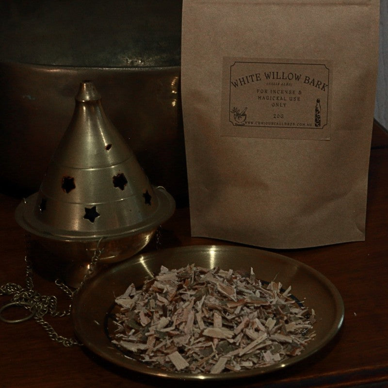 bag of dried willow bark next to censer and gold plate with dried willow bark