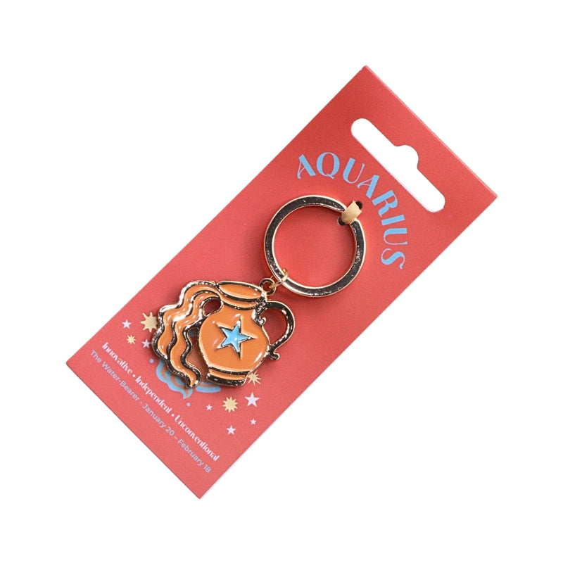 An Aquarius-themed enamel keychain charm on its red cardboard hanger card. The charm features a gold-plated metal ring and body with an orange and blue enamel design depicting a water pitcher and a star.