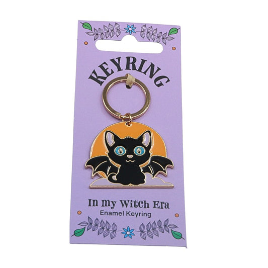 keyring of a bat cat in front of a moon
