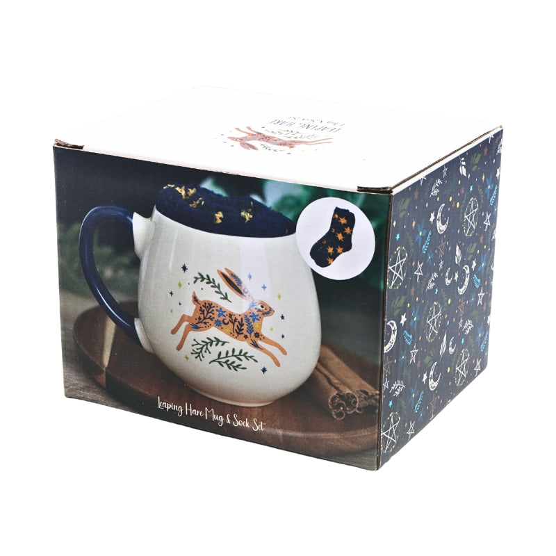 A boxed holiday keepsake cup and sock set, showing the printed packaging with a mug illustration of a hare and a sock design on the box front.