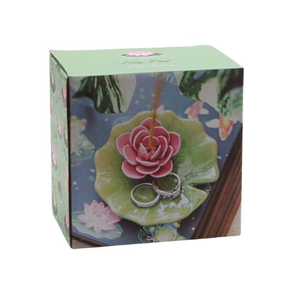 Decorative box with floral design and rings on a white background