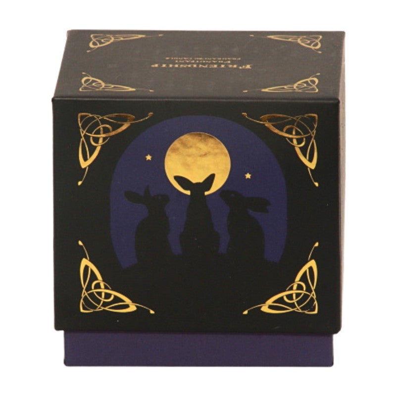 candle gift box-black with blue and gold- featuring 3 hares on front with the word "friendship" written in gold on top.